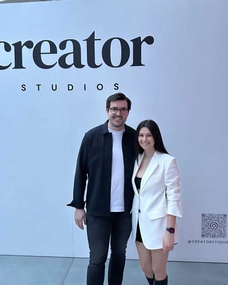 Christian Wenzel with a woman in front of the Creator Studios wall at the opening